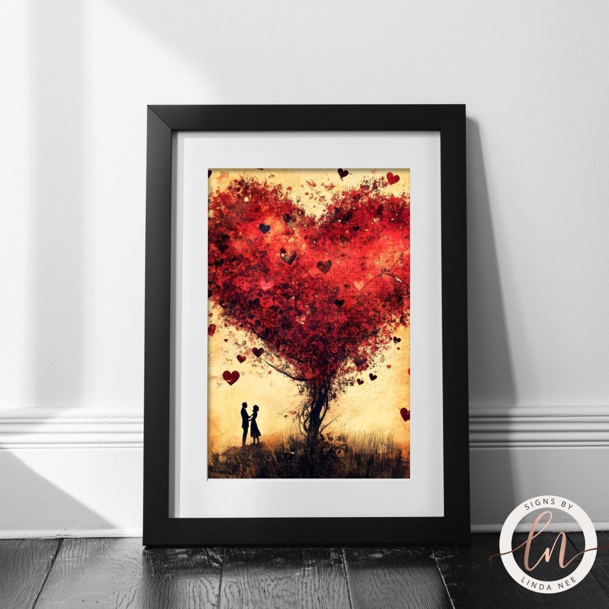Couple beneath a heart tree with red leaves and petals