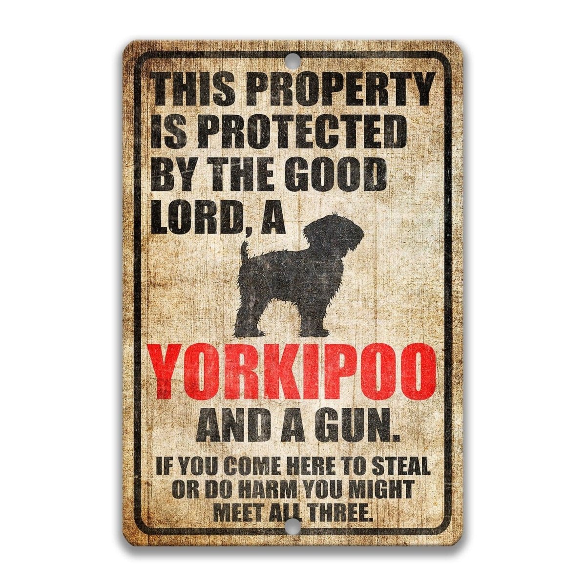 The image is a sign that warns people about the presence of yorkipoo dogs and guns in the area.