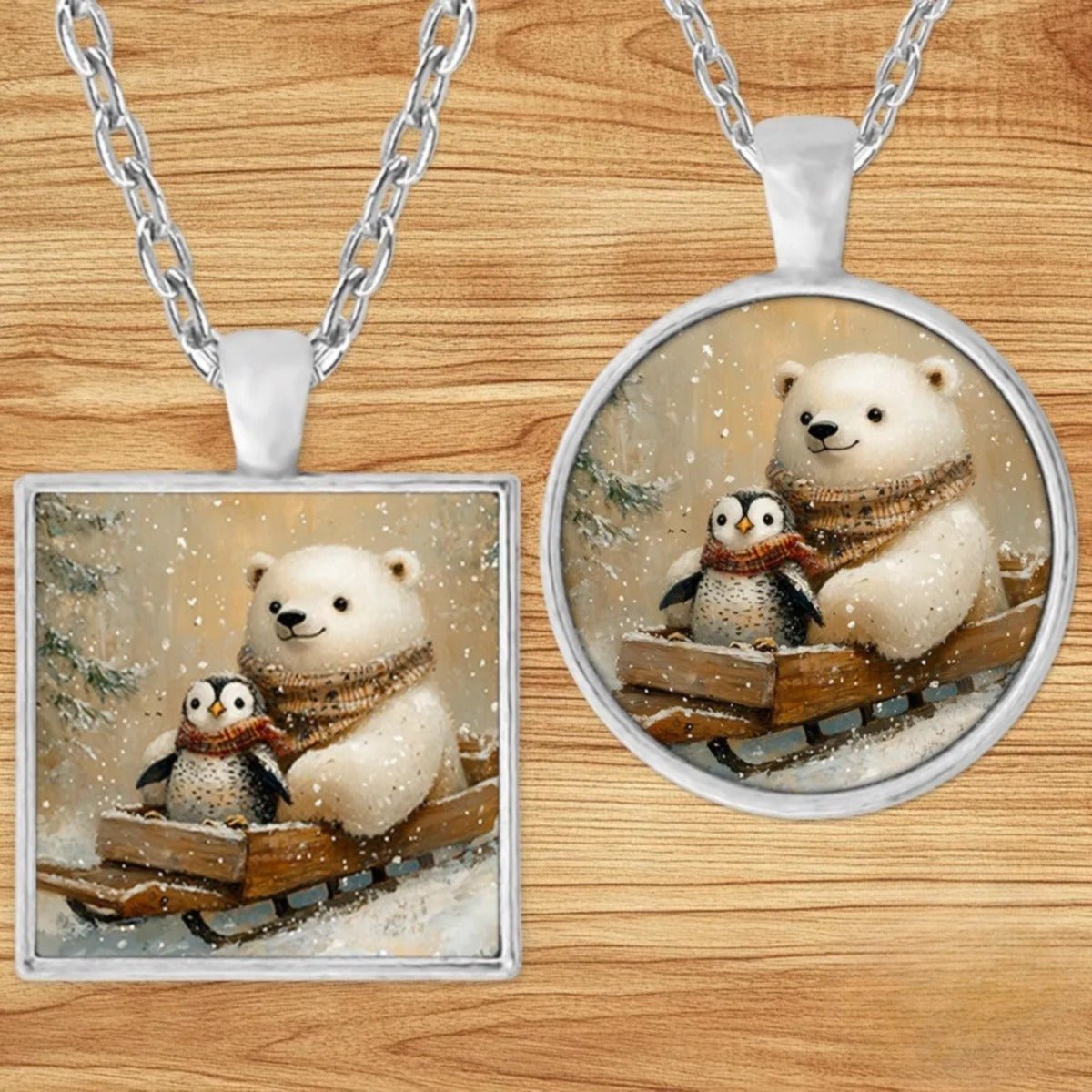 Polar Bear and Penguin Sled pendant necklace shown in round and square silver charm styles on a wood background