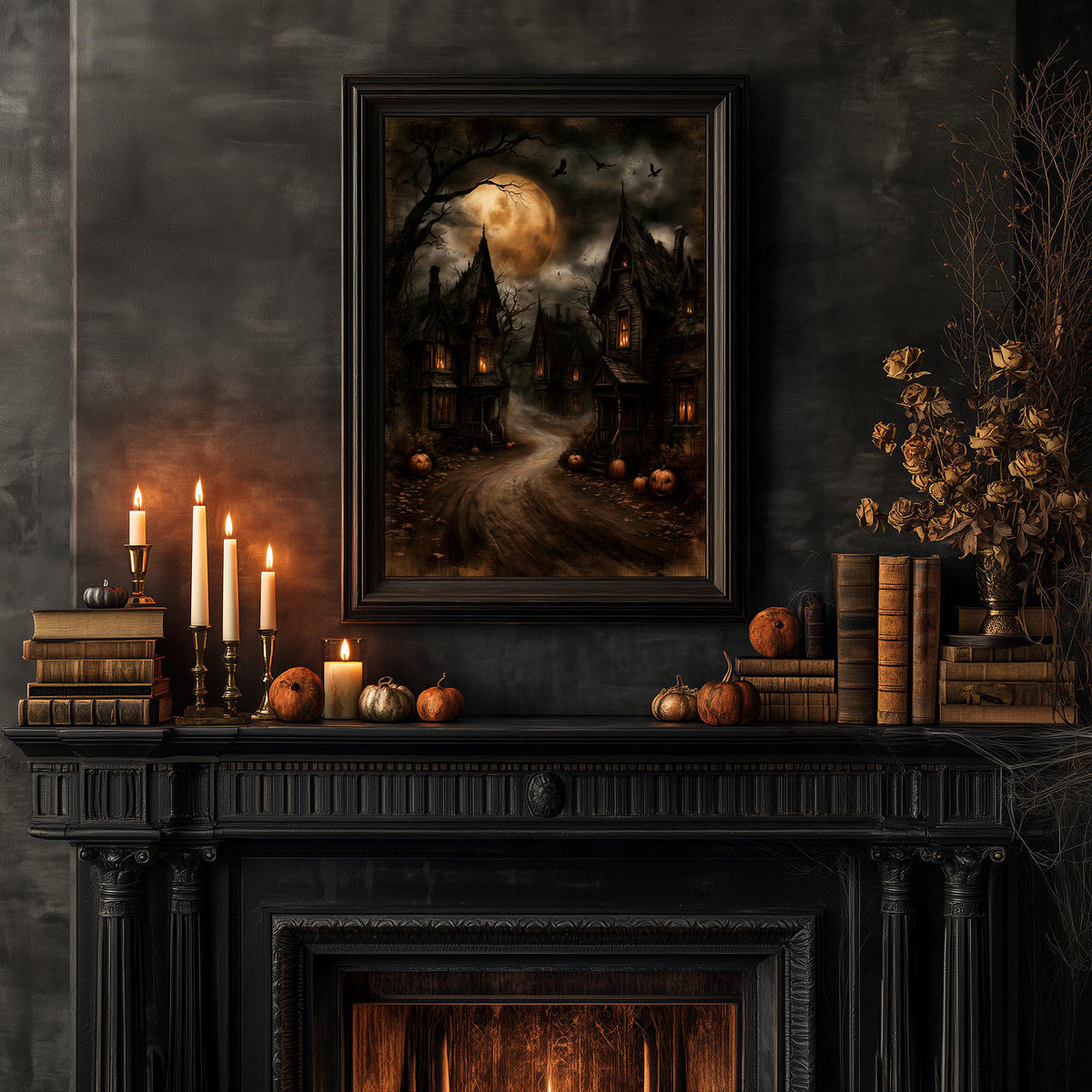Halloween mantel with candles, pumpkins, and books under the haunted village art
