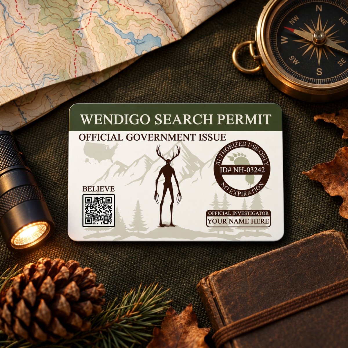a Wendigo Search Permit card, which is an official government issued document, placed on a table surrounded by various items such as a compass, a flashlight, pine cones, and a notebook.