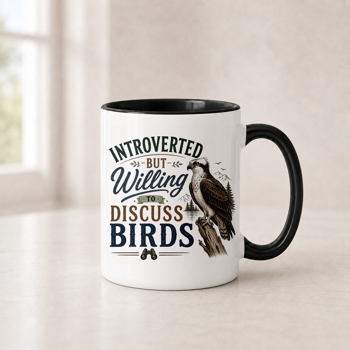 Introverted osprey mug in the 11 oz black handle version with a black interior, on a light counter by a window