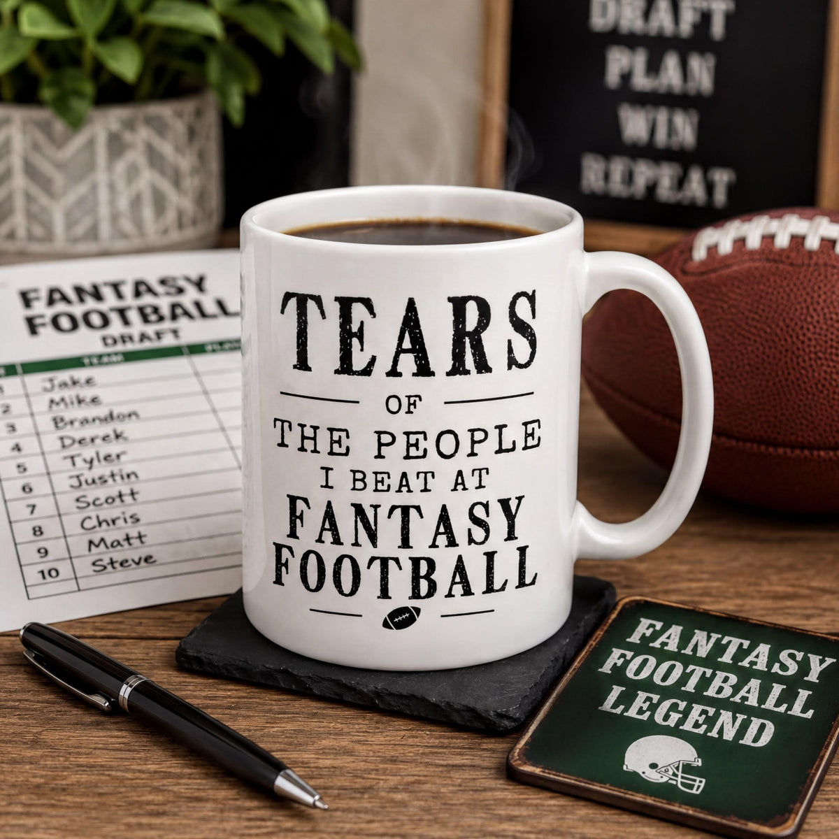 Fantasy football mug on a wooden surface next to a football and a football-themed coaster