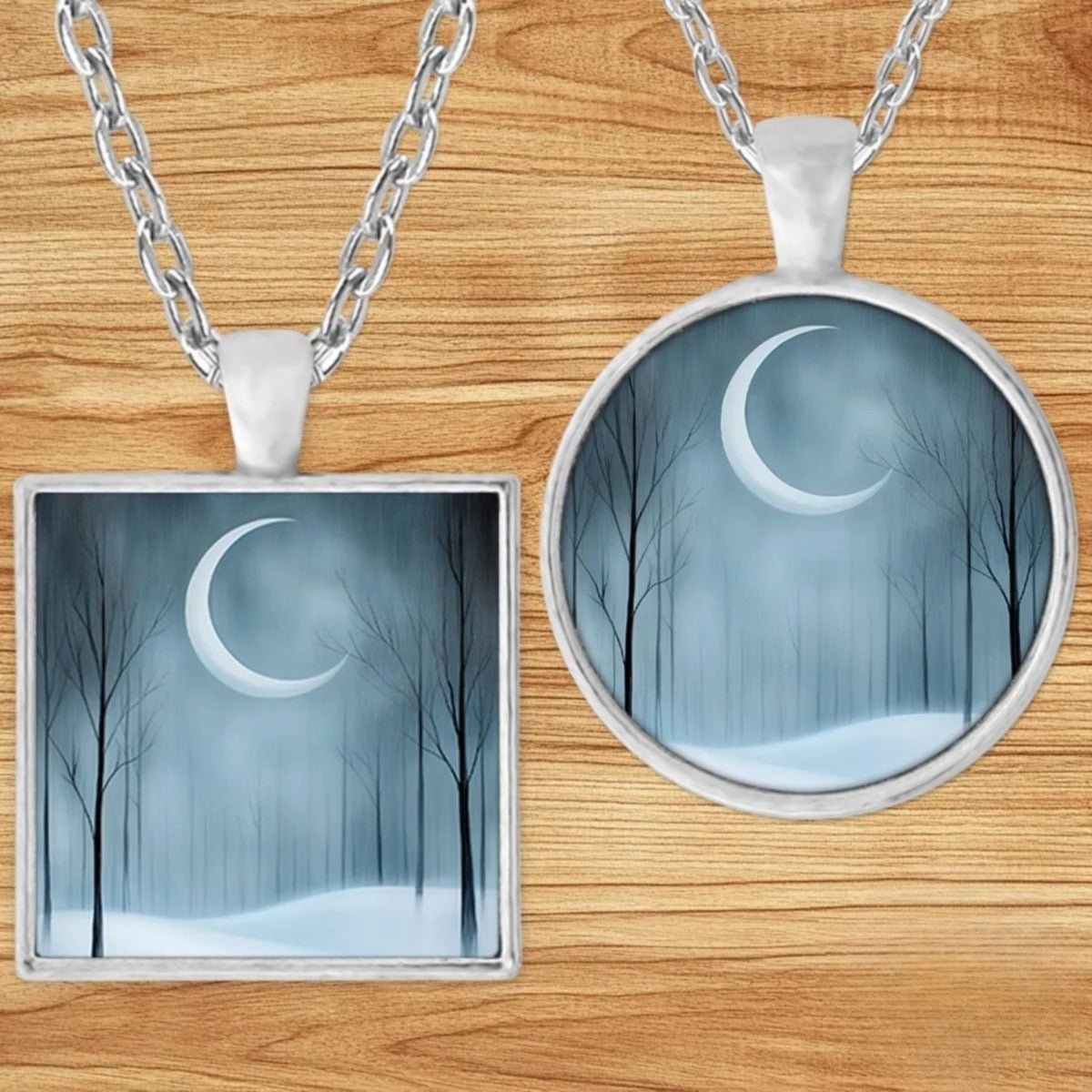 Crescent Moon Winter Solstice pendant necklace shown in round and square silver charm styles on a wood background