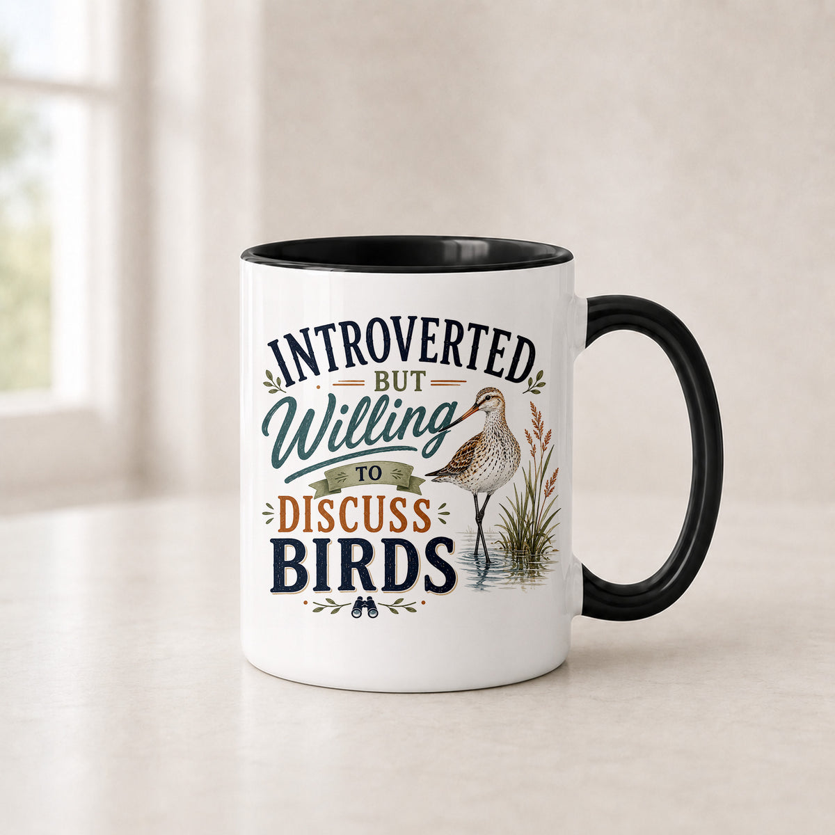 Introverted shorebird mug in the 11 oz black handle version with a black interior, on a light counter