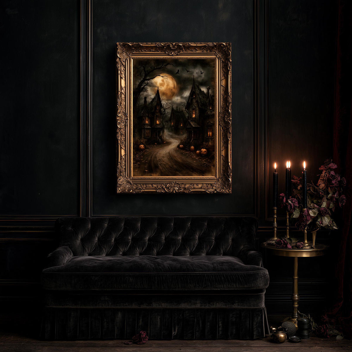 Large village artwork above a black tufted sofa and a table of flowers and candles