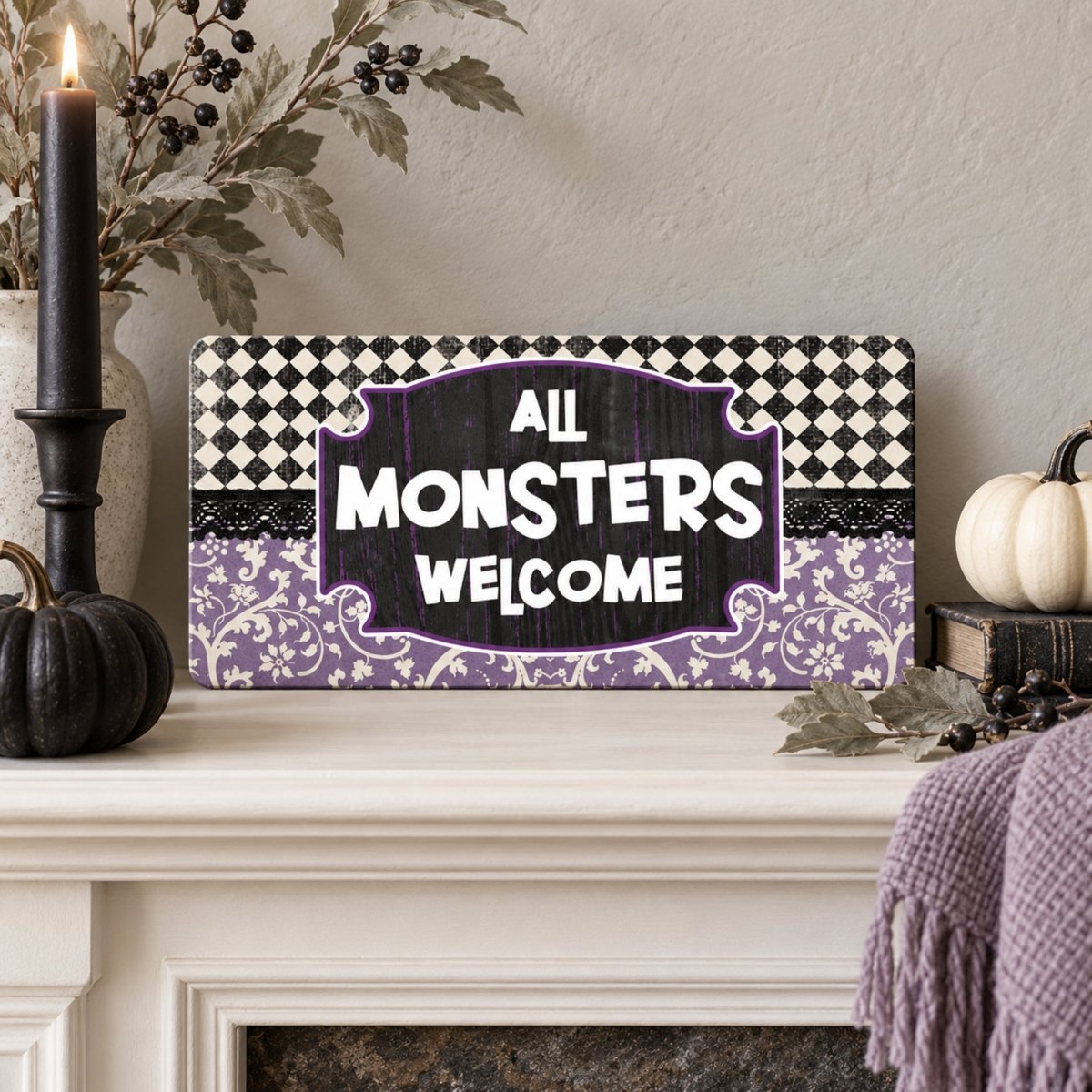 Purple All Monsters Welcome sign on a mantel with Halloween decor