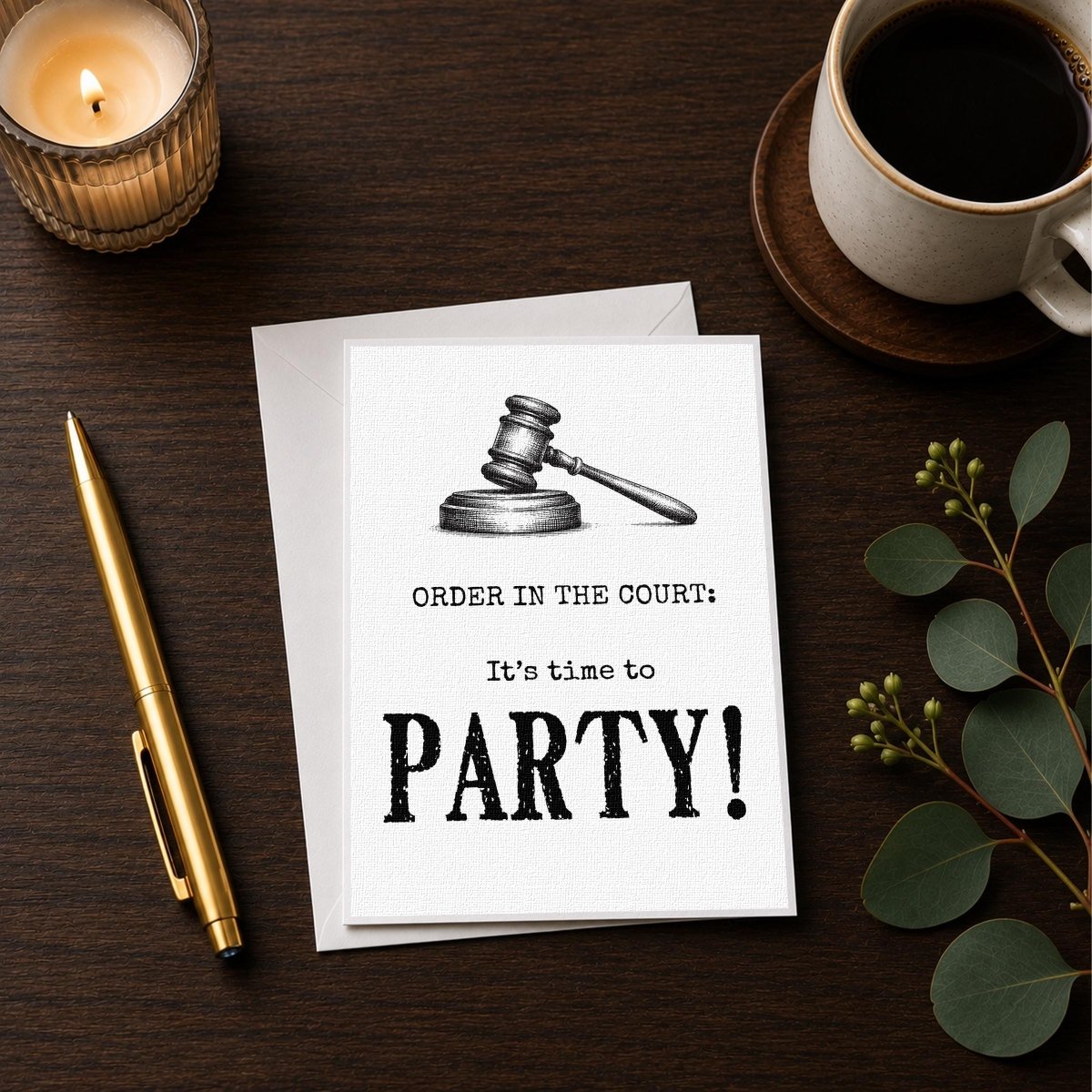 a card with a gavel and the text "ORDER IN THE COURT: It's time to PARTY!" along with a pen and a candle on a wooden surface.