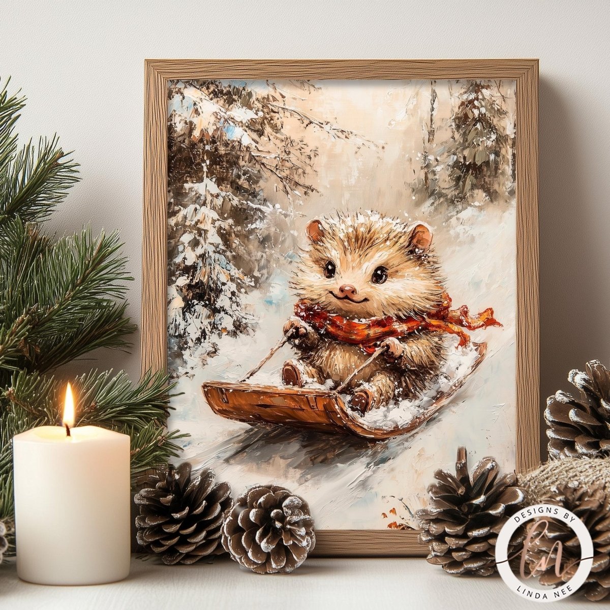 A framed painting of a hedgehog riding a sled in a snowy forest, with pine cones and a lit candle in the foreground.