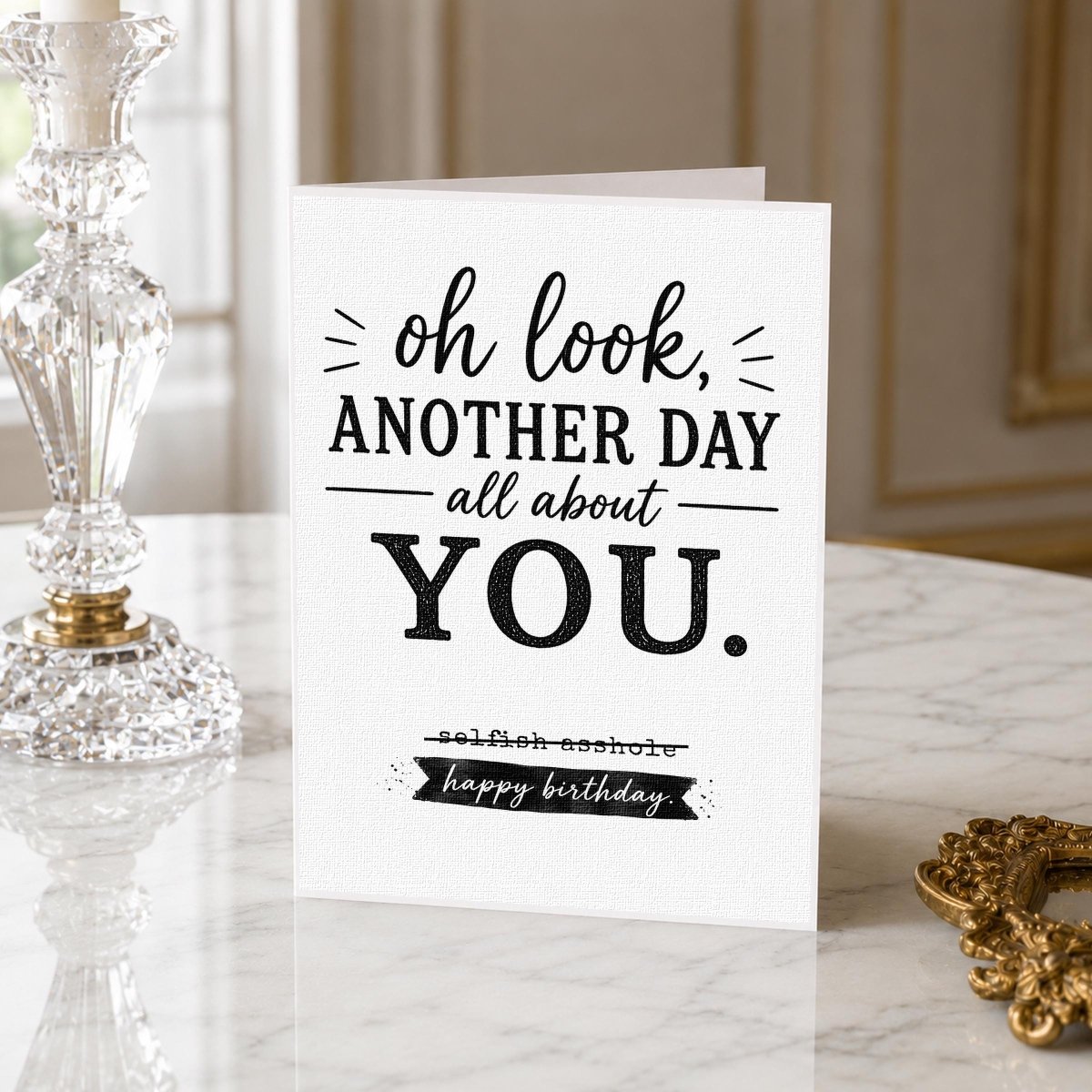 Selfish Birthday Card for Best Friend displayed on a marble surface beside a crystal vase.