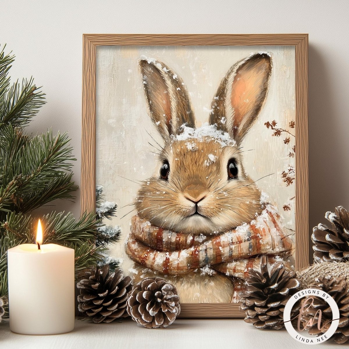 A framed painting of a rabbit wearing a scarf and surrounded by pine cones and a lit candle, creating a cozy winter scene.