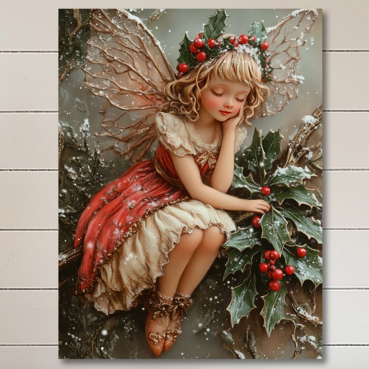 Winter fairy in a red dress seated on a holly branch with berries and snow