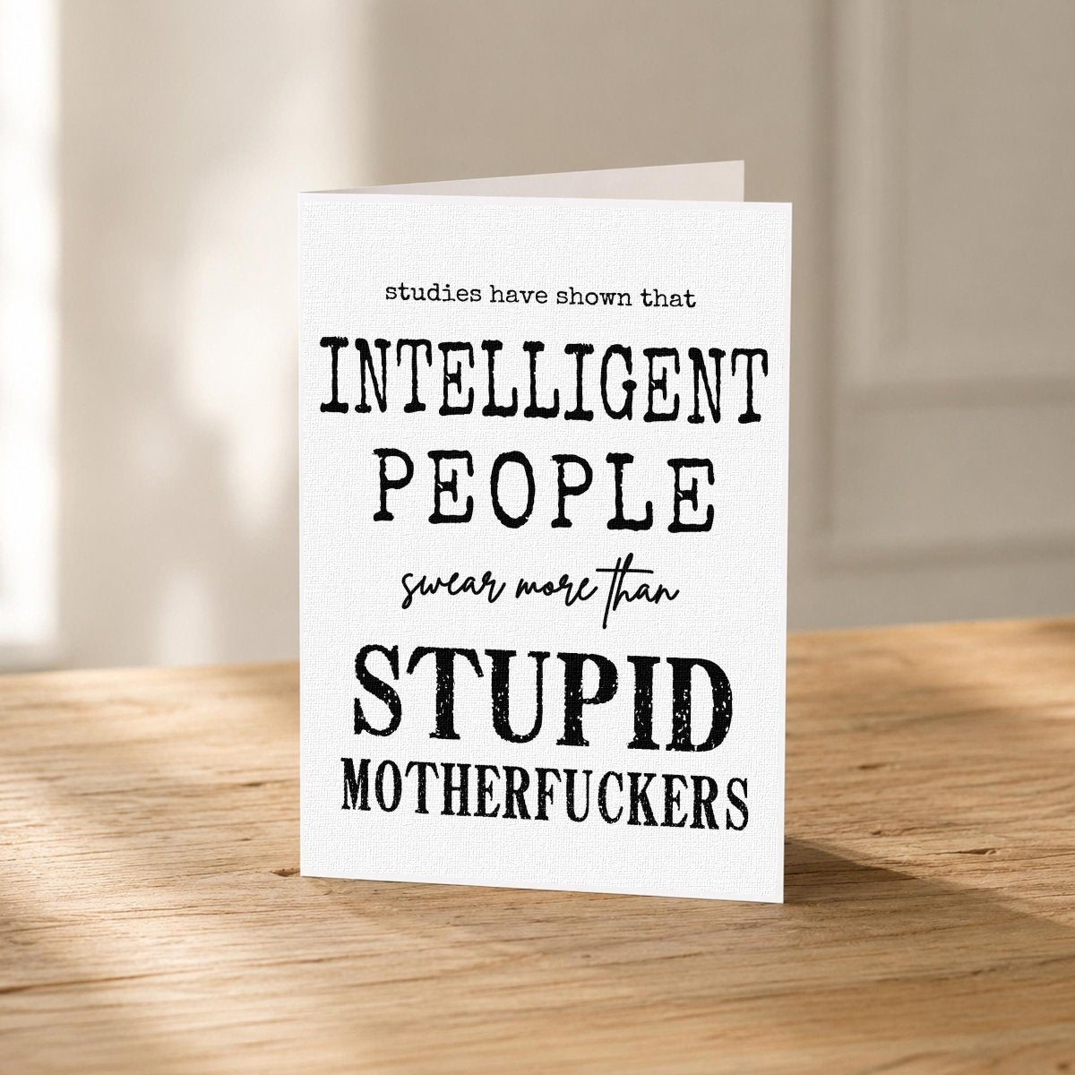Close-up of the Smart People Swear Just Because Card showing the crisp black typography design.
