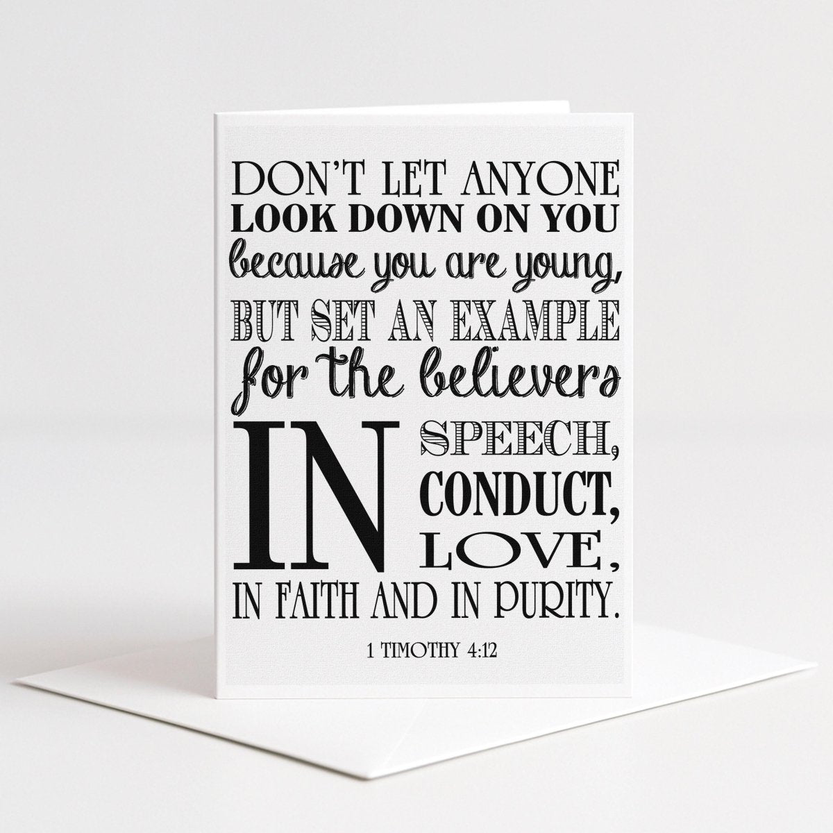 White 5x7 Christian greeting card featuring 1 Timothy 4:12 in bold black mixed typography with the scripture “Don’t let anyone look down on you because you are young” and the words speech, conduct, love, faith and purity.