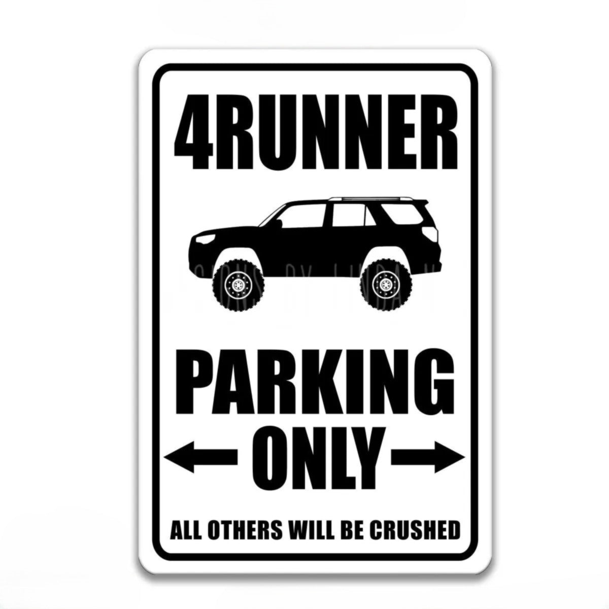 A sign that reads "4RUNNER PARKING ONLY" with an illustration of a 4-wheel drive vehicle.