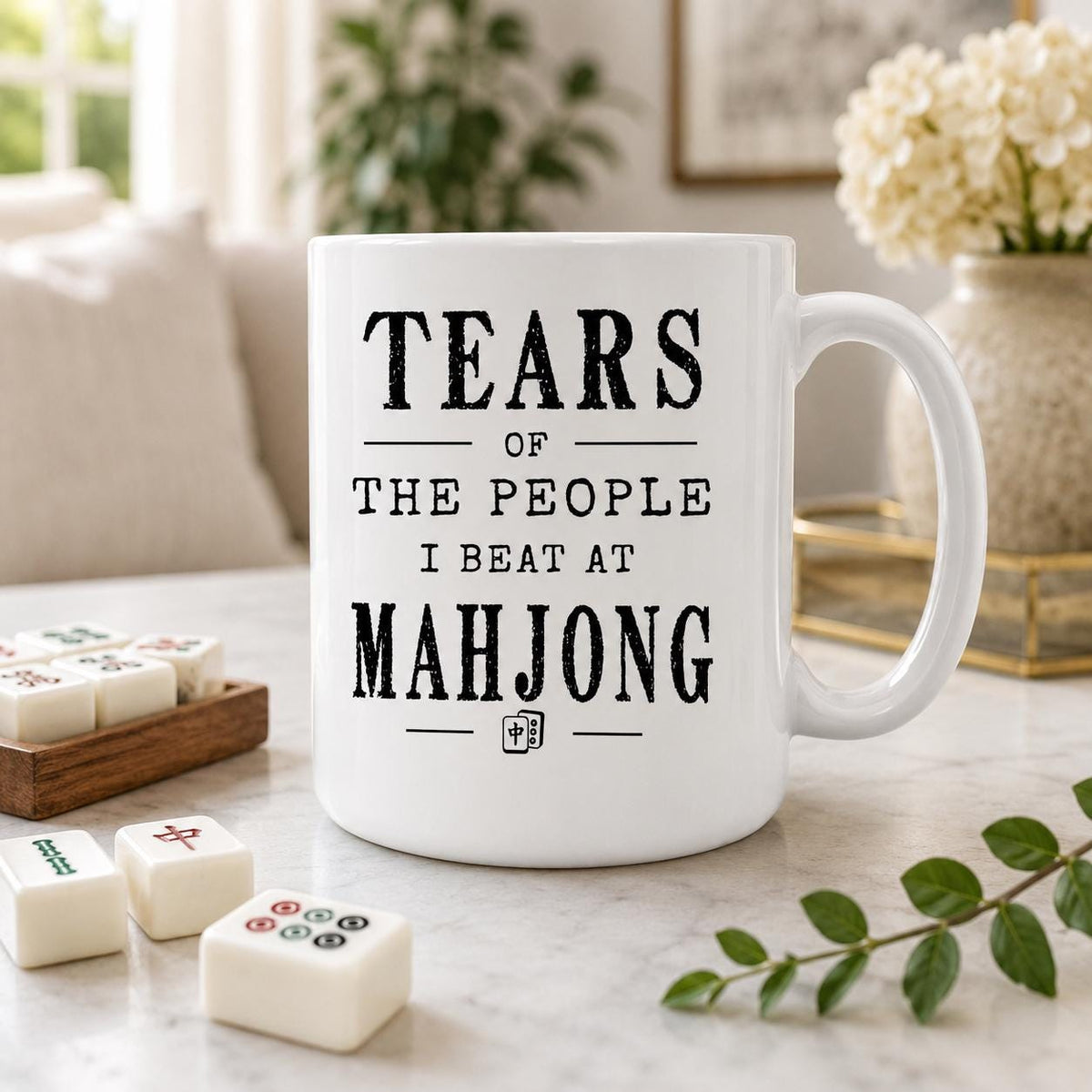 Mahjong mug on a table beside a wooden tray and game tiles, quote reading Tears of the people I beat at mahjong