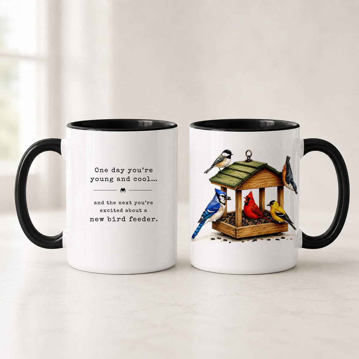 Black handle bird feeder mugs shown front and back, with a black interior, the typewriter quote and painted birds