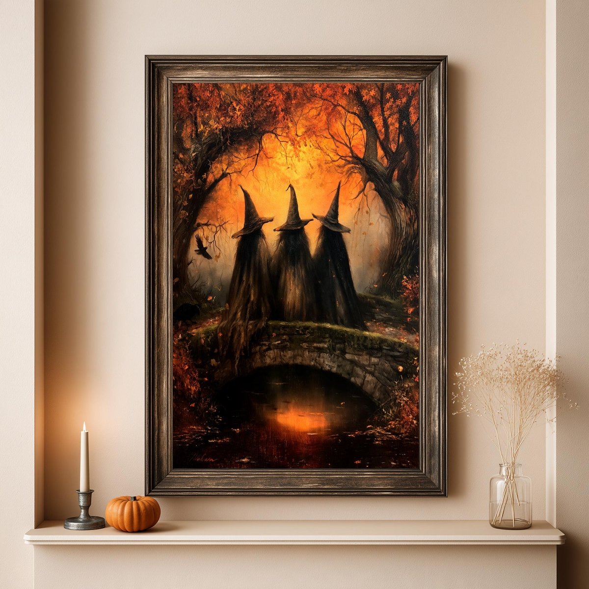 Autumn witches art print above a shelf with a pumpkin and candle