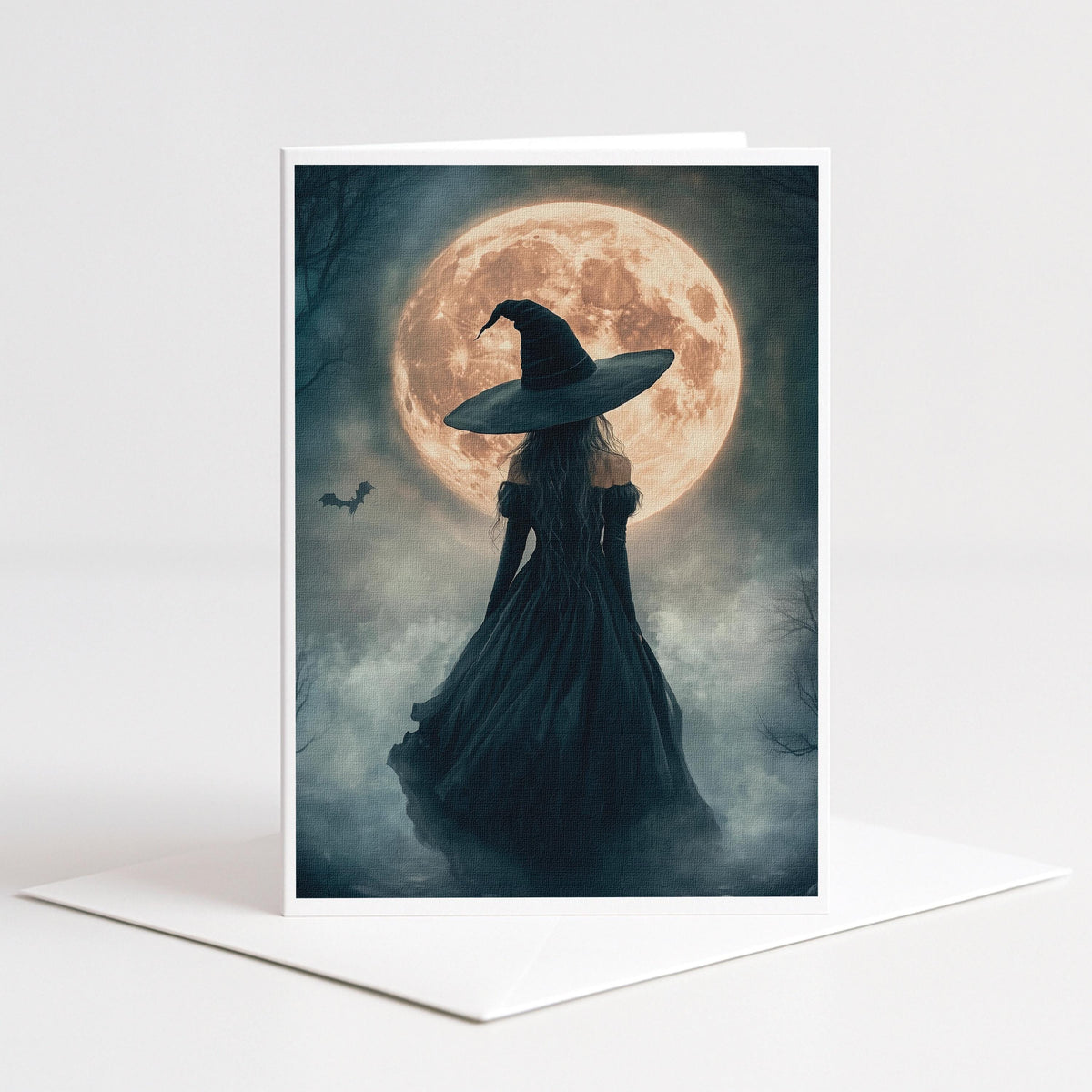 Witch and a flying bat before a glowing harvest moon, 5x7 blank note card