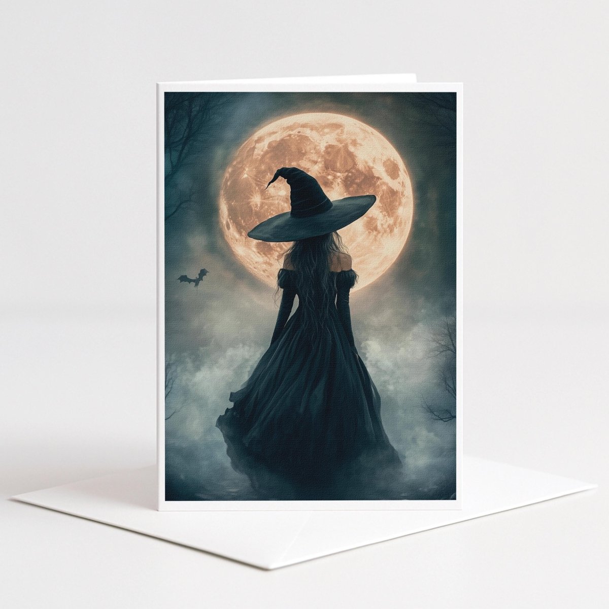 Witch and a flying bat before a glowing harvest moon, 5x7 blank note card