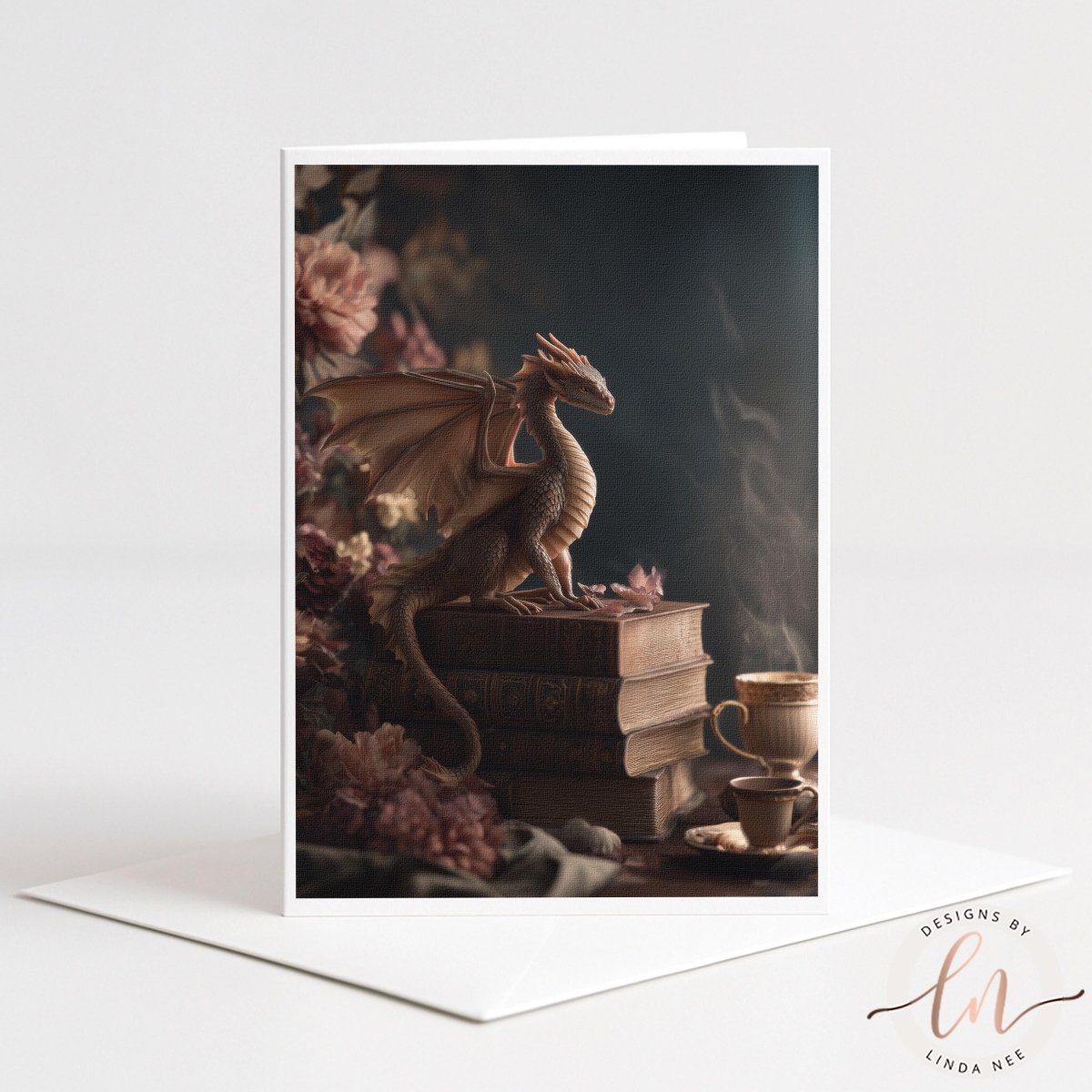 A dragon figurine perched on a stack of books, with a cup of tea nearby, set against a backdrop of pink flowers.