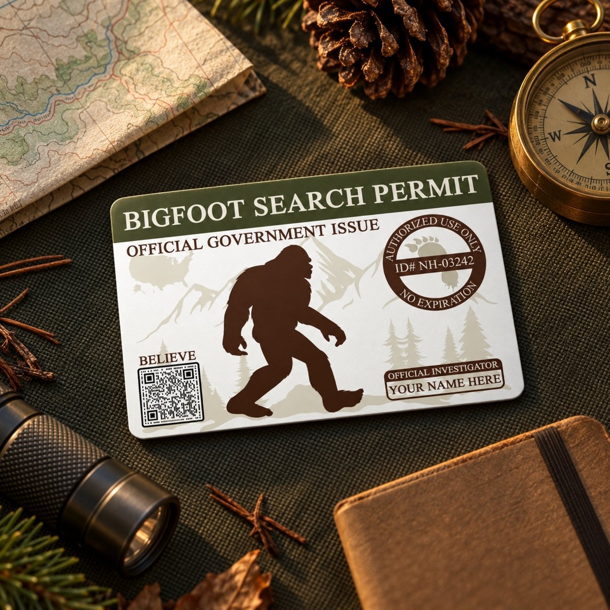 a search permit for Bigfoot, with various items such as a compass, a flashlight, and pine cones surrounding it.