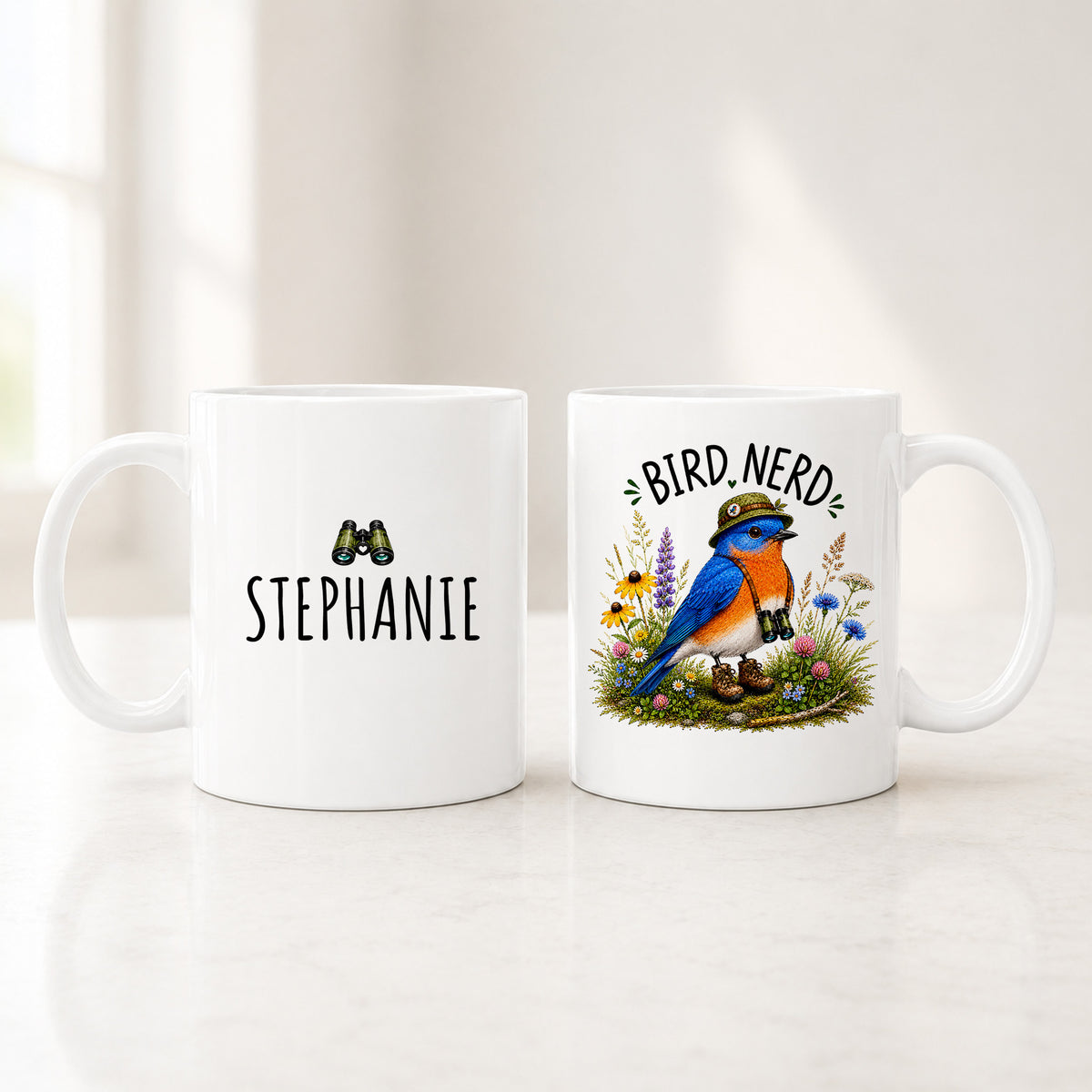 Both sides of the 11 oz personalized bluebird mug, a custom name on the back and the Bird Nerd bluebird on the front