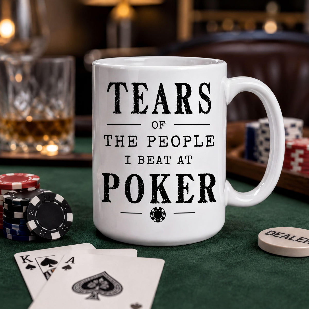 Poker mug on a game table with stacks of poker chips and playing cards spread around it