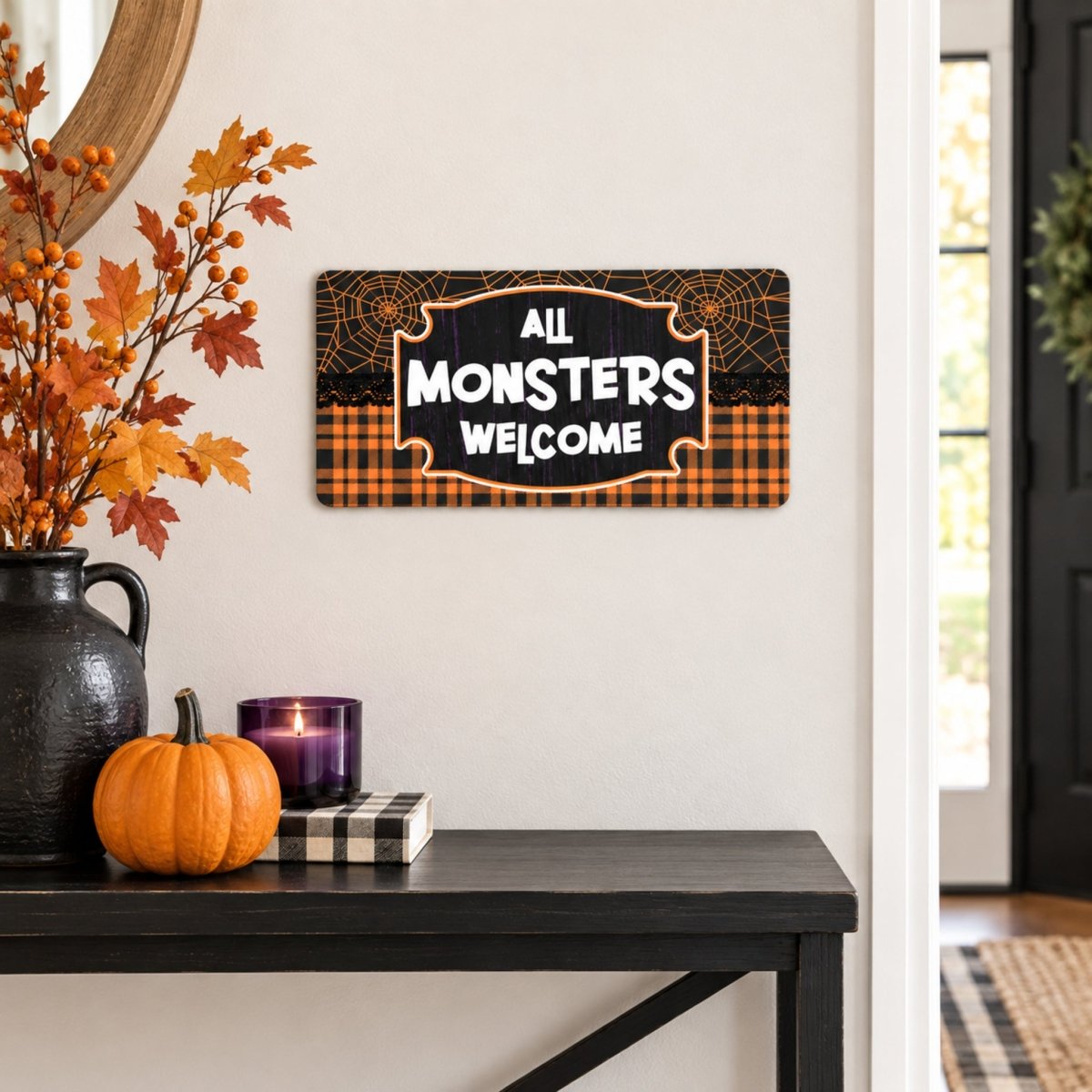 Plaid All Monsters Welcome sign on a wall above a table