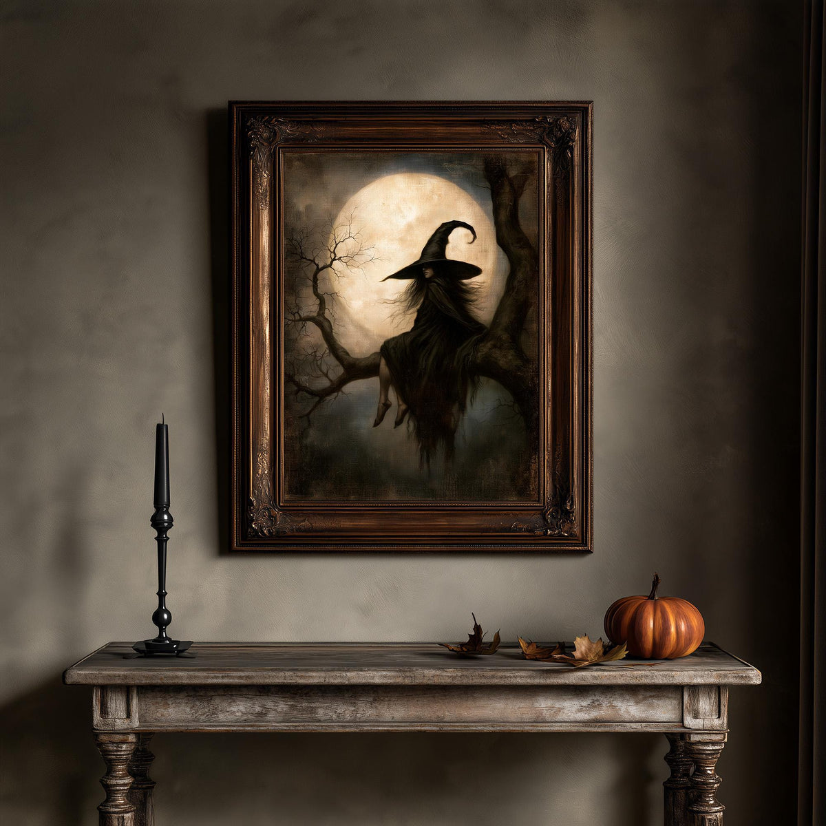 Gothic wall art above a wooden table holding a candle and a small pumpkin