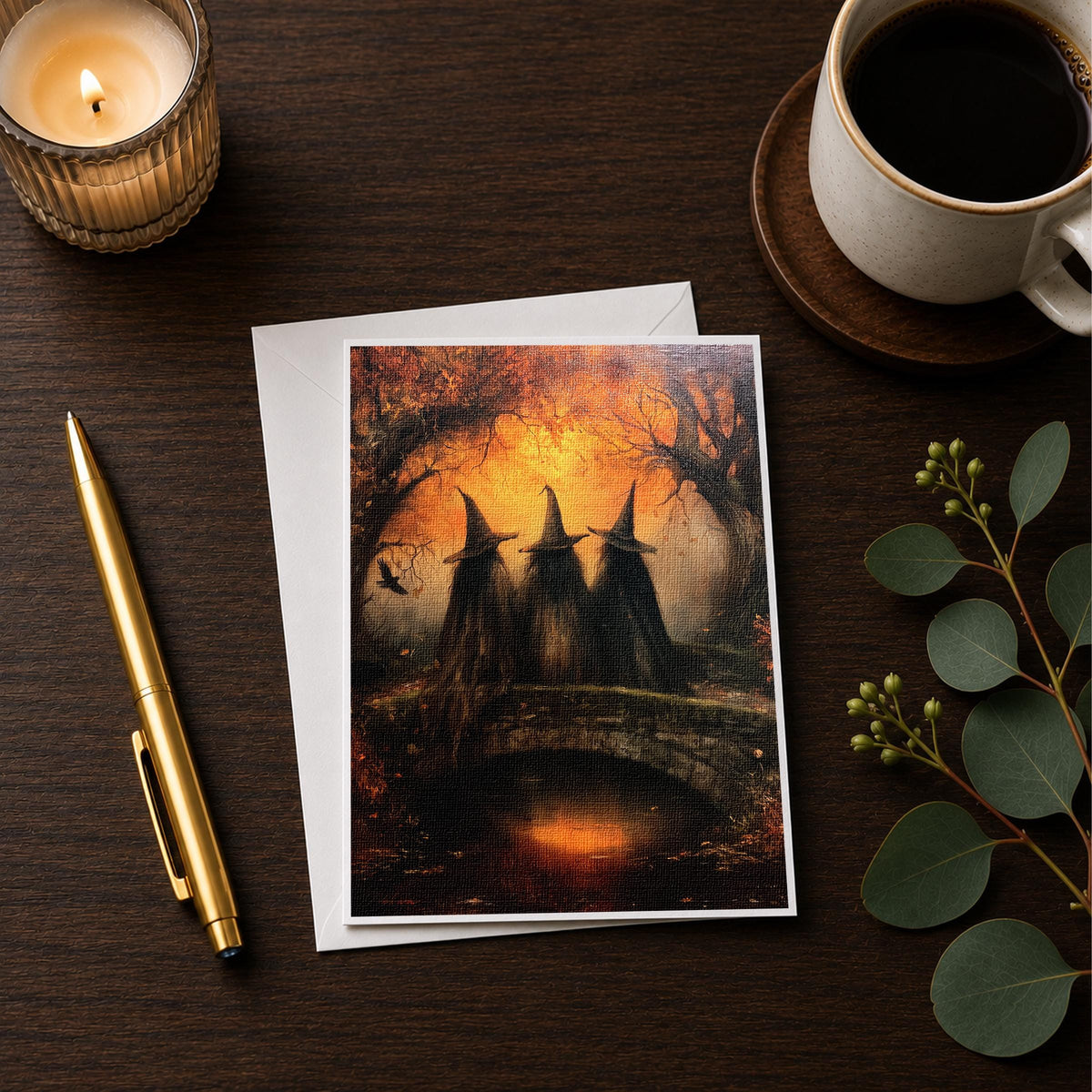 Three witches bridge note card styled on a wooden desk with a candle and coffee