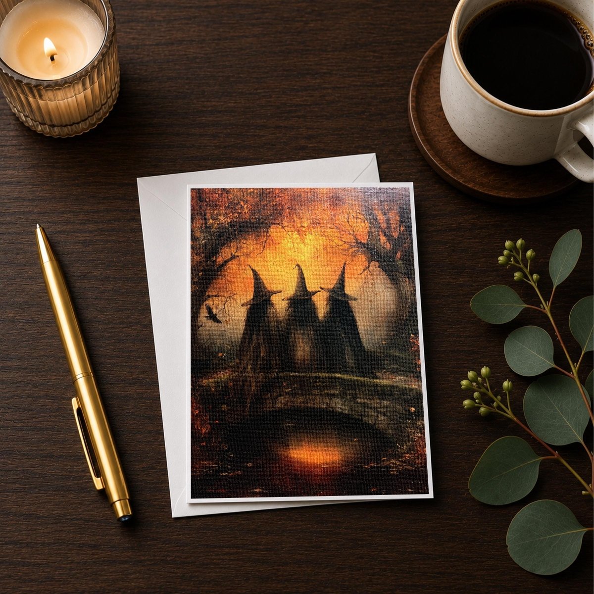 Three witches bridge note card styled on a wooden desk with a candle and coffee