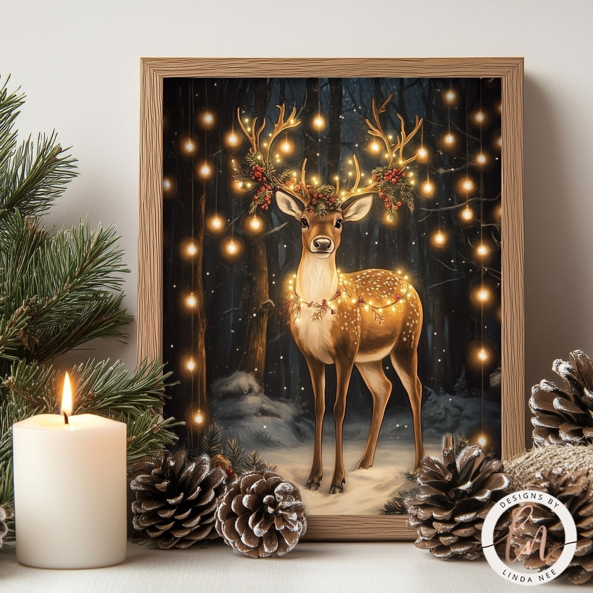 A framed illustration of a deer with antlers and a wreath on its head, surrounded by Christmas lights and pine cones, creating a festive holiday scene.
