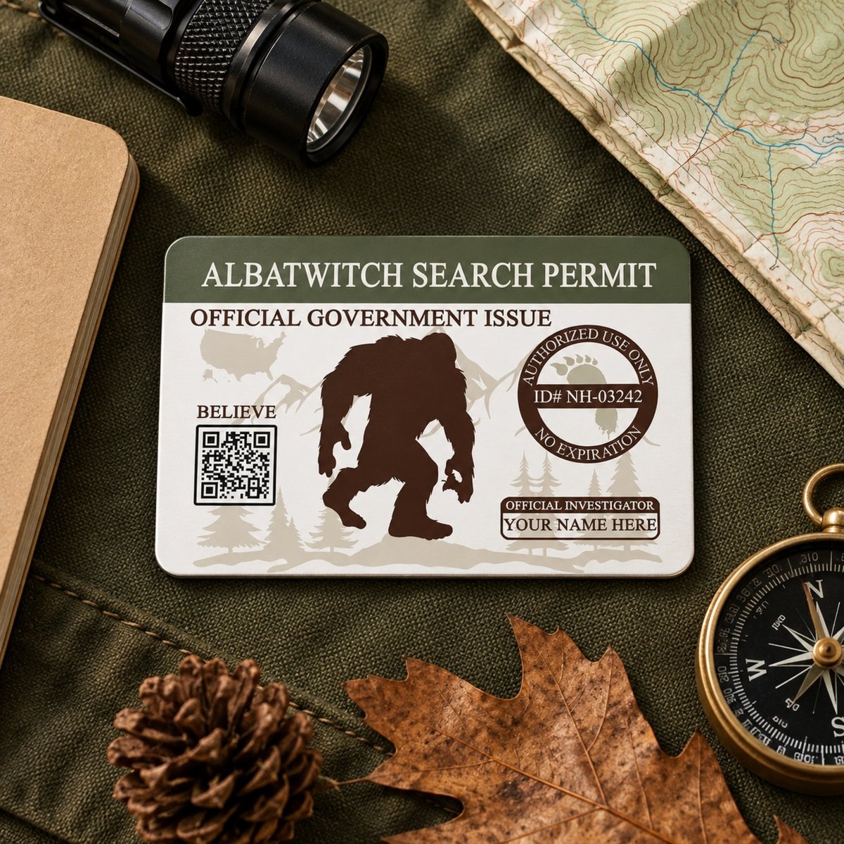 a search permit with a silhouette of a Sasquatch, a mythical creature, and various outdoor gear such as a compass, flashlight, and map.