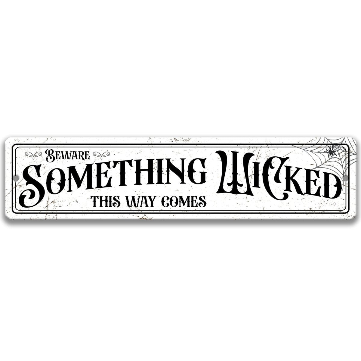 Beware Something Wicked This Way Comes street sign in vintage lettering with a spider web