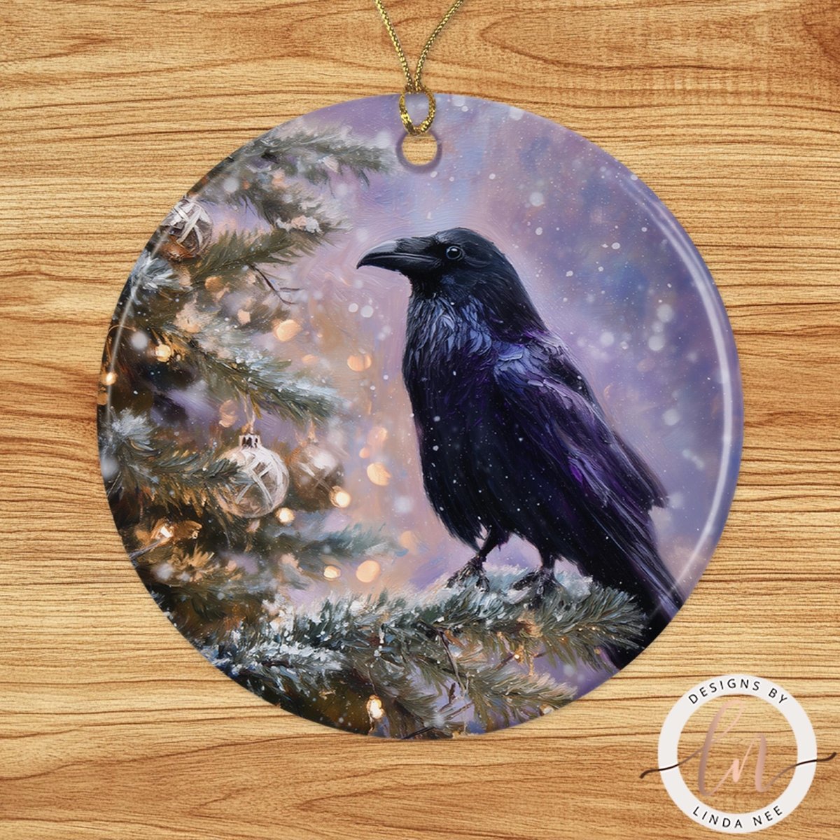 A black crow perched on a snowy branch, with a Christmas tree and twinkling lights in the background.