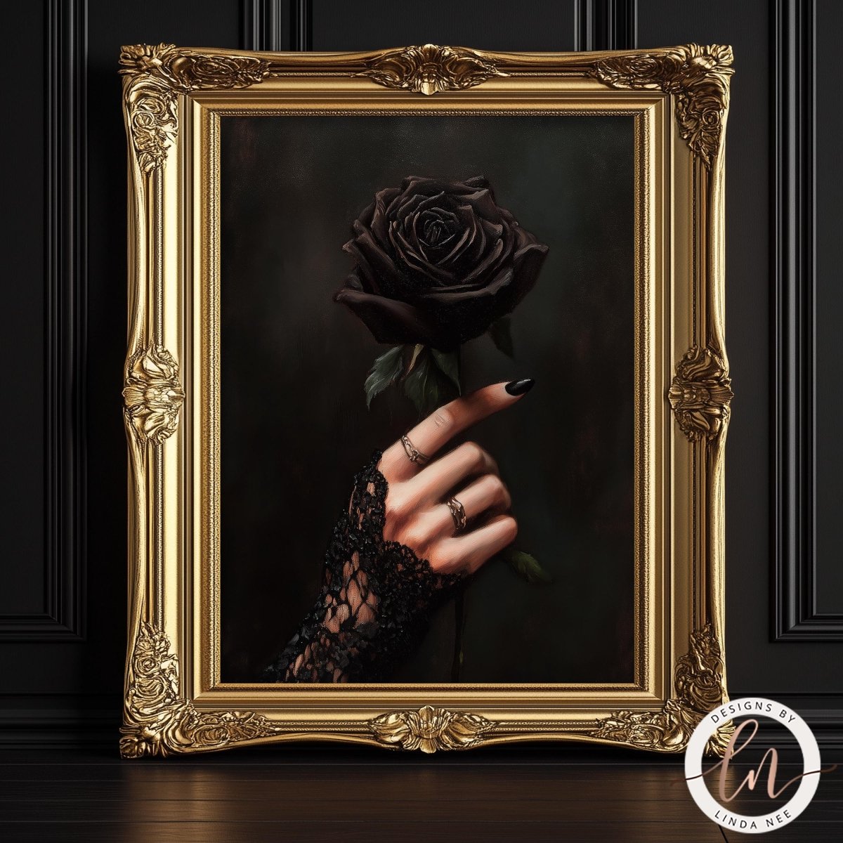 Decorative gold frame with a dark rose and hand holding it against a black background.