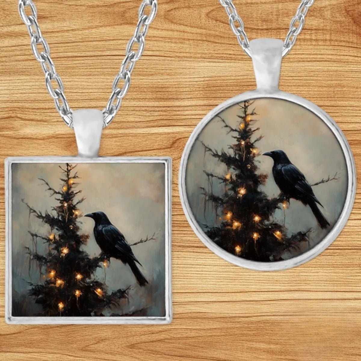 Gothic Christmas Raven pendant necklace shown in round and square silver charm styles on a wood background