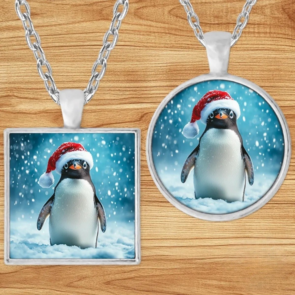 Christmas Penguin Santa Hat pendant necklace shown in round and square silver charm styles on a wood background