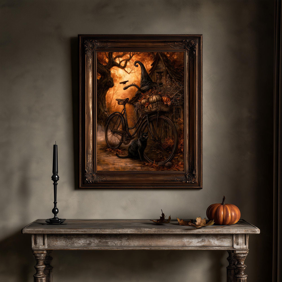 Autumn bicycle art print above a wooden table set with a candle and a small pumpkin