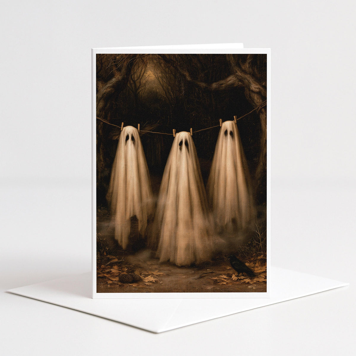 Three ghosts pegged to a clothesline in an autumn forest, 5x7 blank note card by Designs by Linda Nee