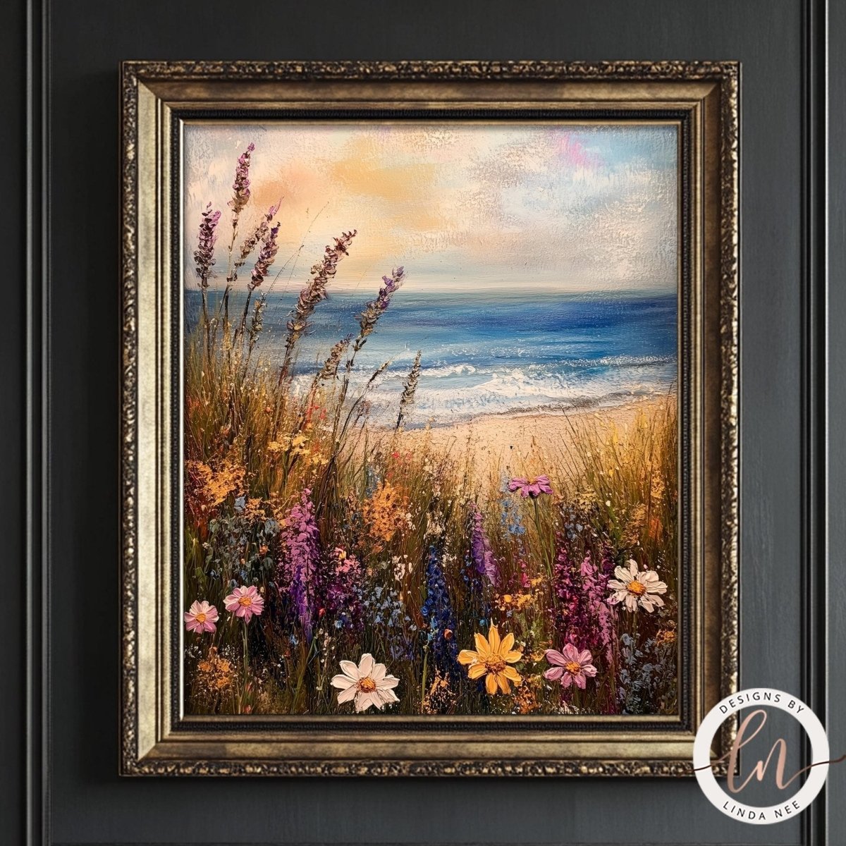 The image is a framed painting depicting a serene beach scene with a field of colorful wildflowers in the foreground and the ocean in the background.