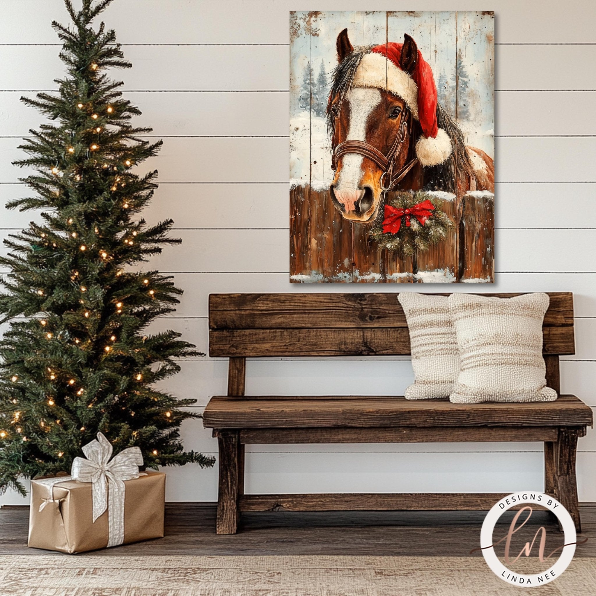a wooden bench with a Christmas tree and a wreath on a wall, along with a framed painting of a horse wearing a Santa hat.
