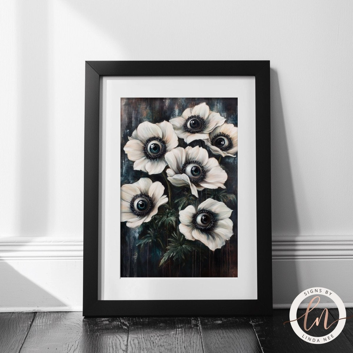White flowers with black centers artwork on a white wall