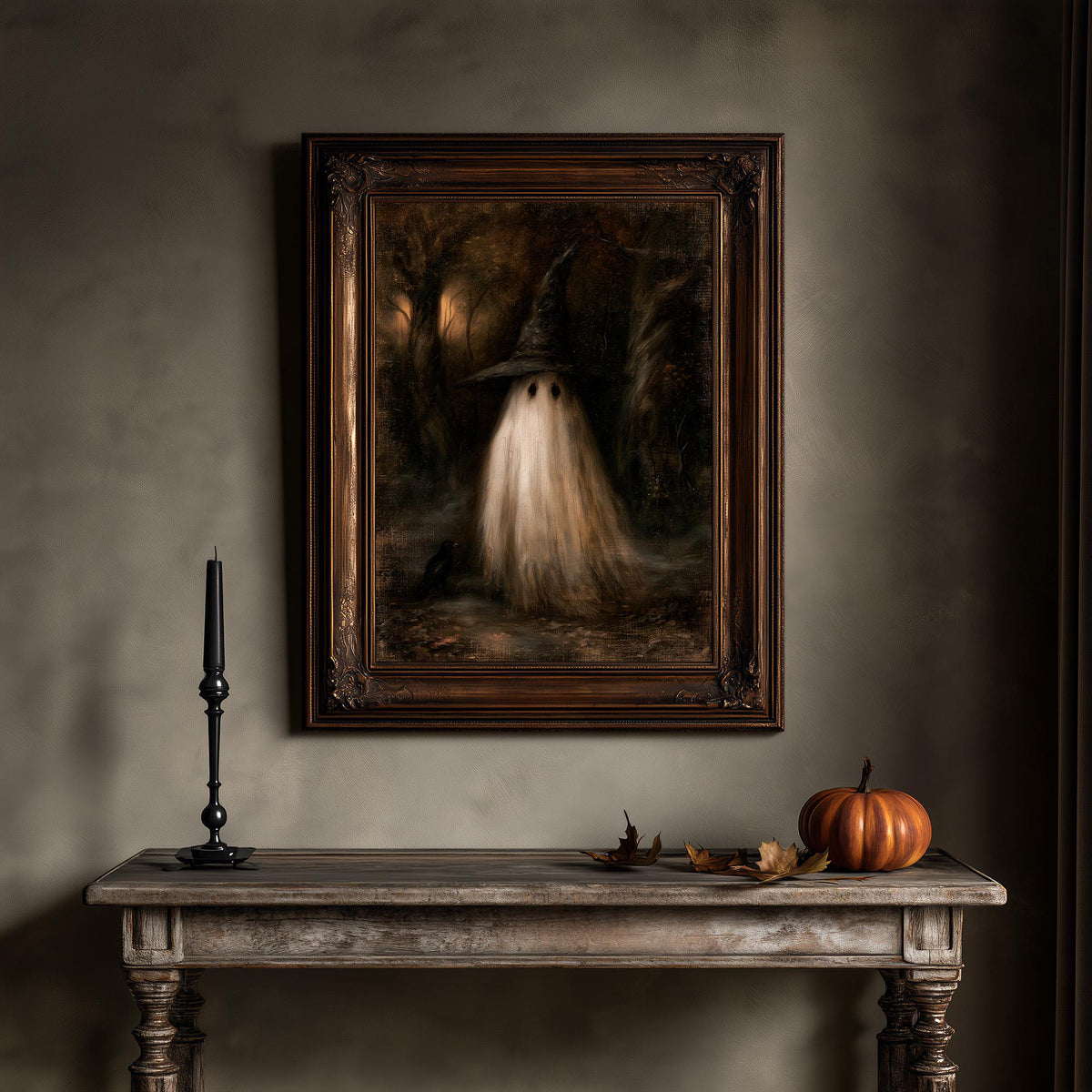Witchcore wall art above a wooden table holding a candle and a small pumpkin