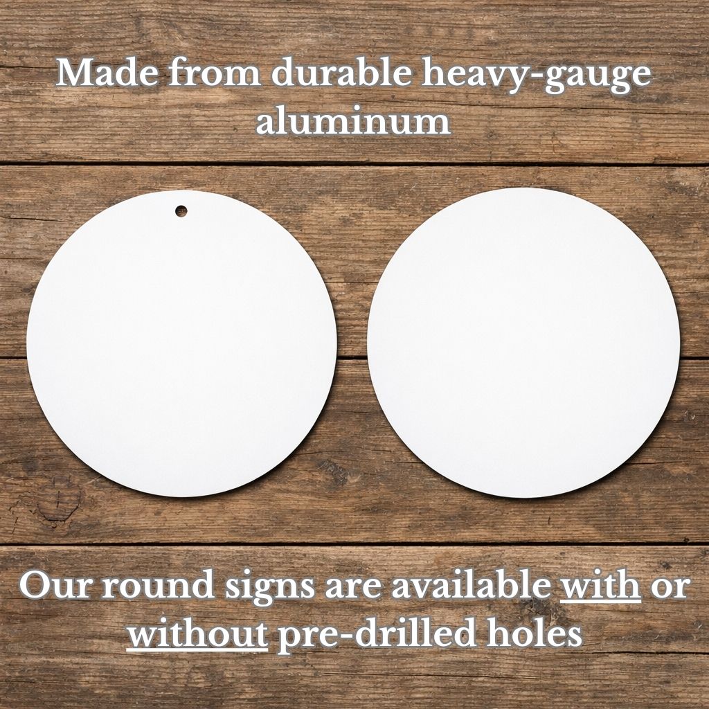 two white round signs, one with a hole in the center and the other without a hole, placed on a wooden surface.