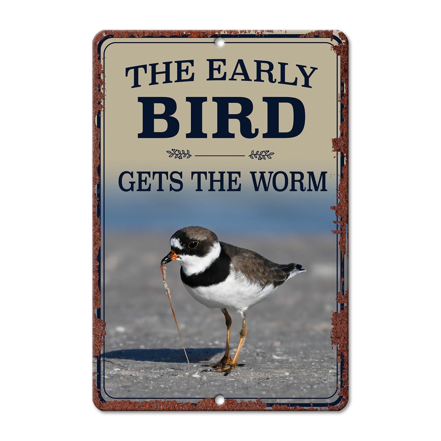 A sign with the text "The early bird gets the worm" and an image of a bird standing on a beach.