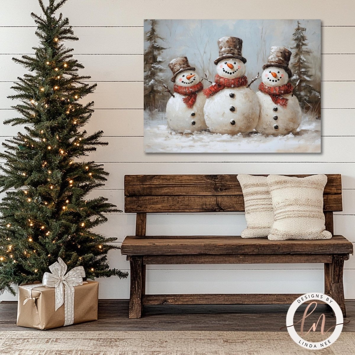 Snowmen in top hats and scarves artwork beside a wooden bench and lit tree