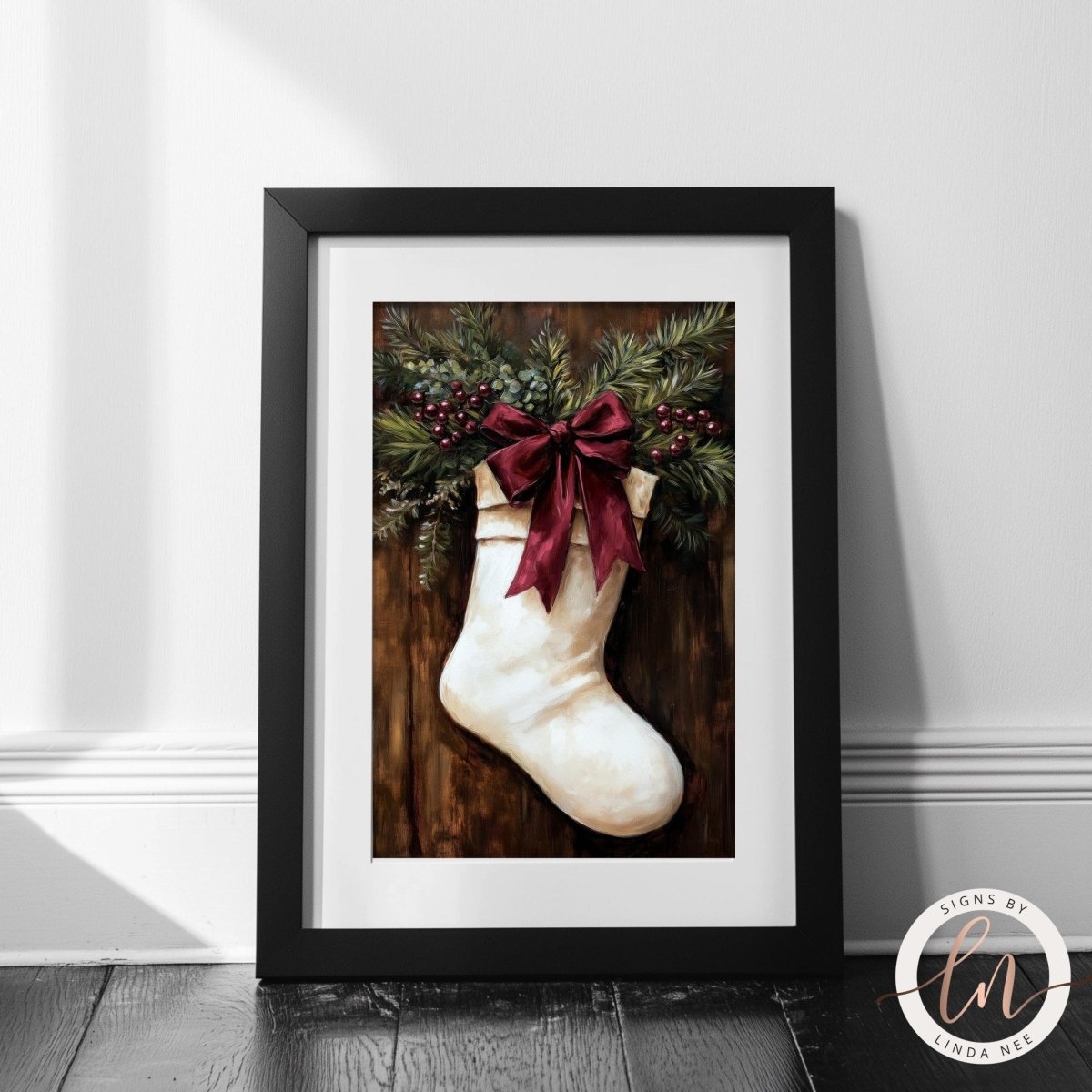 Stocking with pine and berries artwork against a plain white wall