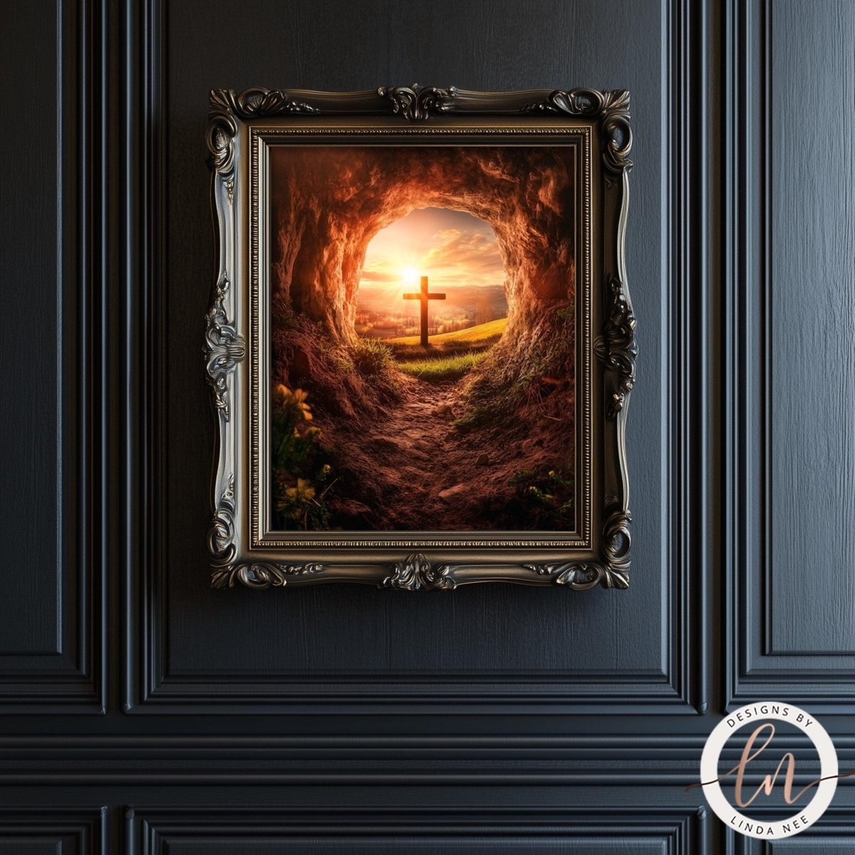 A framed image depicting a cross in a cave with a sunset in the background.